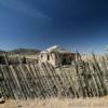 This some old ranch house.
(through the fence)